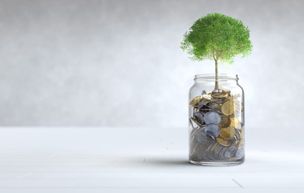 Coins growing out of a glass jar. An illustration of how investing works. Image source - freepik.